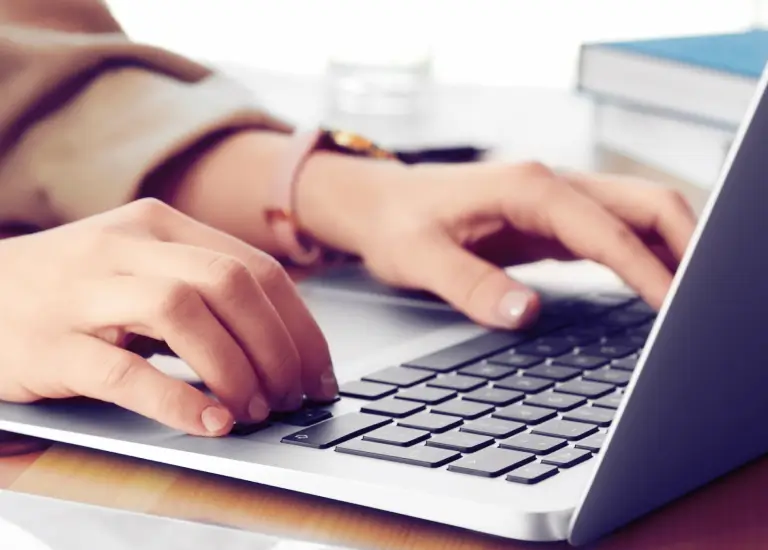 
a person typing on a laptop